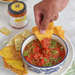 Bowl of salsa with tortilla chips and a jar of salsa on a plate.