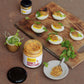 Honey mustard spread on deviled eggs with a jar of honey mustard on a wooden board.