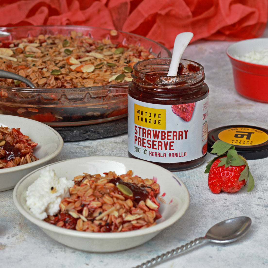 Dish of food with strawberry preserve jar on a table